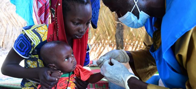 © UNICEF/Frank Dejongh A baby is tested for malaria at a community health centre in Chad.