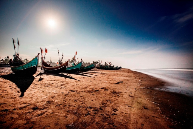 Fishing boats such as these, beached on a strip of coast in Teknaf, Bangladesh, are often used to ferry passengers to larger vessels in the Bay of Bengal bound for Thailand or Malaysia. Photo: UNHCR/S. Alam